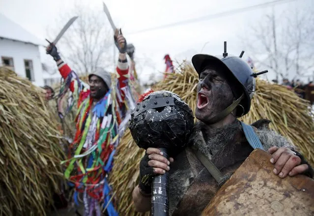 Local residents dressed in costumes perform during celebrations for the Malanka holiday in the village of Krasnoilsk in the Chernivtsi region of Ukraine, January 14, 2016. (Photo by Valentyn Ogirenko/Reuters)