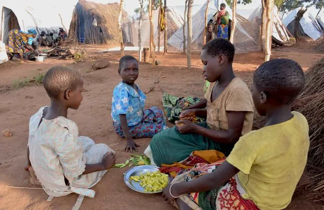Mozambican child refugees prepare food at Kapise camp in Malawi's Mwanza district January 18, 2016. Thousands of Mozambicans have fled across the border to refugee camps in Malawi in the last month, saying Mozambique's Frelimo government forces are burning homes and killing civilians in a campaign against Renamo guerrillas in an escalation of a simmering conflict between old civil war foes. Spokesmen for both Frelimo and Renamo each told Reuters that the other side was responsible for attacks on their members in various parts of the country but would not give details about the violence that prompted the refugee exodus. (Photo by Eldson Chagara/Reuters)
