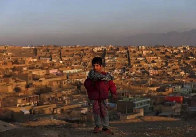 An Afghan boy stands near his house in Kabul, Afghanistan November 25, 2015. (Photo by Mohammad Ismail/Reuters)