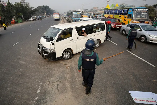 Bangladeshi police officers stop a vehicle carrying Muslim activists who were try to join a long march towards Myanmar to protest against the deaths of Rohingya Muslims in the Rakhine state of Myanmar, in Dhaka, Bangladesh, December 18, 2016. (Photo by Mohammad Ponir Hossain/Reuters)