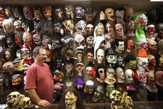 John Helmer sells Halloween masks at Fantasy Costumes on October 30, 2013 in Chicago, Illinois. Although Halloween spending has increased more than 50 percent since 2005, according to the National Retail Federation spending for the holiday this year is expected to be slightly lower than it was in 2012. (Photo by Scott Olson/AFP Photo)