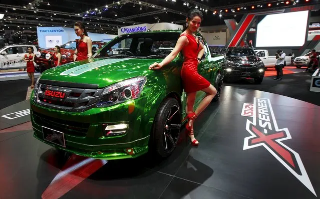 Models pose beside a Isuzu X-Series during a media presentation of the 36th Bangkok International Motor Show in Bangkok March 24, 2015. (Photo by Chaiwat Subprasom/Reuters)