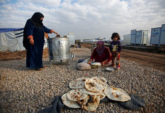 Displaced women, who fled the Islamic State stronghold of Mosul, make bread at Hassan Sham camp, east of Mosul, Iraq  December 27, 2016. (Photo by Khalid al Mousily/Reuters)