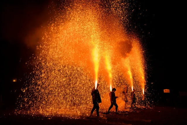 Participants launch handheld fireworks during the Tezutsu Hanabi celebration at the Inaba shrine in Gifu, Japan on February 4, 2016. (Photo by Aflo/Barcroft Media)