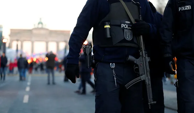 German policemen patrol with submachine gun at the Brandenburg Gate, ahead of the upcoming New Year's Eve celebrations in Berlin, Germany, December 30, 2016. (Photo by Fabrizio Bensch/Reuters)
