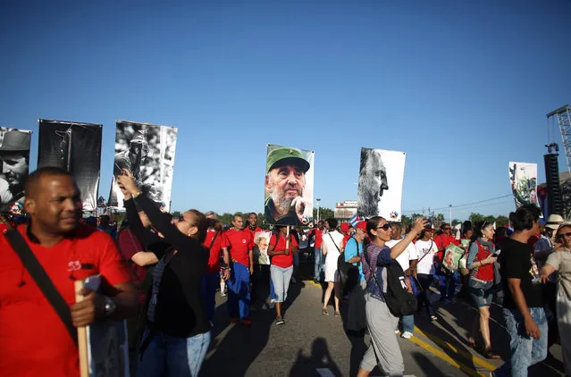 People march with images of Cuba's late President Fidel Castro to mark the Armed Forces Day and commemorate the landing of the yacht Granma, which brought the Castro brothers, Ernesto “Che” Guevara and others from Mexico to Cuba to start the revolution in 1959, in Havana, Cuba, January 2, 2017. (Photo by Alexandre Meneghini/Reuters)