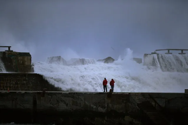 Representatives from the Basque regional government observe damage to a sea wall caused by huge waves at the port of Bermeo, northern Spain February 9, 2016. (Photo by Vincent West/Reuters)