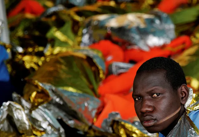 A migrant looks on onboard the former fishing trawler Golfo Azzurro after he was rescued along with other migrants, including children and pregnant women, by the Spanish NGO Proactiva Open Arms as the raft he was on drifted out of contol in the central Mediterranean Sea, some 36 nautical miles off the Libyan coast, January 3, 2017. (Photo by Yannis Behrakis/Reuters)