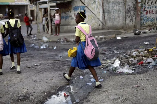 A school girl steps over a puddle in Port-au-Prince, Haiti, January 27, 2016. (Photo by Andres Martinez Casares/Reuters)