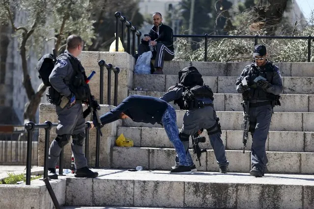 Israeli police perform a body search on a Palestinian man at Damascus Gate in Jerusalem's Old City February 16, 2016. (Photo by Ammar Awad/Reuters)