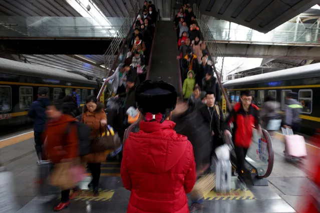 Travellers head for their train at Beijing Railway Station during the annual Spring Festival travel rush ahead of the Chinese Lunar New Year, China, January 31, 2019. (Photo by Thomas Peter/Reuters)