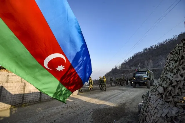 Russian peacekeepers are seen deployed at the Lachin corridor, the Armenian-populated breakaway Nagorno-Karabakh region's only land link with Armenia, as Azerbaijani environmental activists protest what they claim is illegal mining, on December 26, 2022. Azerbaijani activists who have blocked the sole road connecting Karabakh with Armenia rejected on December 26 Yerevan's accusations of provoking a humanitarian crisis in the enclave. But locals in Karabakh interviewed by AFP decried the dire consequences of the blockade, which they say is aimed at chasing ethnic Armenians from the region. (Photo by Tofik Babayev/AFP Photo)