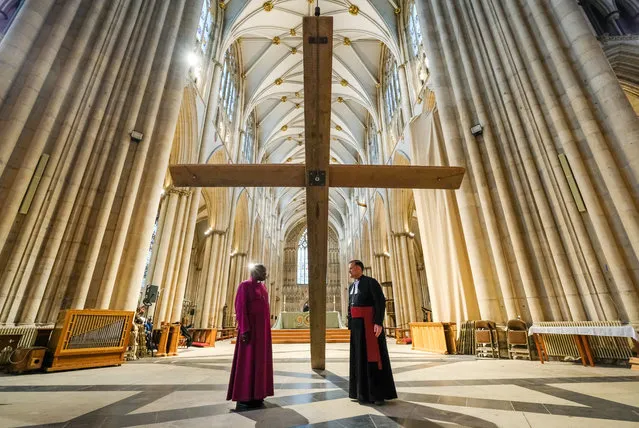 The Archbishop of York, Dr John Sentamu (L) and The Dean of York, the Right Reverend Dr Jonathan Frost attend a media call as a wooden cross is suspended from York Minster's Central Tower as part of the Minster's preparations to mark the season of Lent at York Minster on March 05, 2019 in York, England. Lent begins on Ash Wednesday and ends on the Feast of Pentecost and is the most solemn period in the Christian Calendar. Constructed from rough lengths of scaffolding wood by the Minster's Works Department the cross measures six metres tall and three metres wide. (Photo by Ian Forsyth/Getty Images)