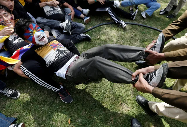 Police officers detain a Tibetan during a protest held to mark the 60th anniversary of the Tibetan uprising against Chinese rule, outside Chinese embassy in New Delhi, India on March 12, 2019. (Photo by Adnan Abidi/Reuters)