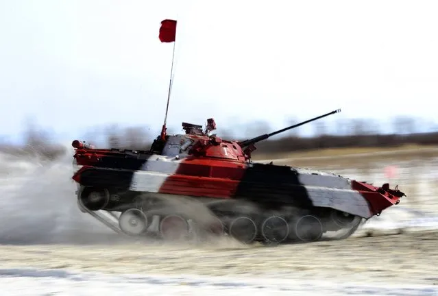 A tank crew competes in an individual race at a regional stage of the 2016 Tank Biathlon Competition at the Anastasyevsky training ground, March 1, 2016, Khabarovsk Territory, Russia. (Photo by Yuri Smityuk/TASS/Newscom)