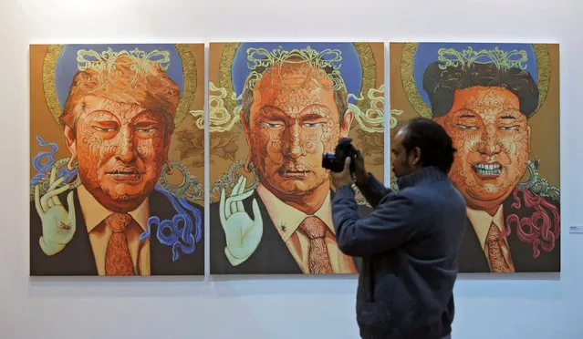 A visitor clicks pictures in front of an exhibit titled “Peace Owners” by Nepali artist Sunil Sigdel at the India Art Fair in New Delhi, India February 3, 2017. (Photo by Adnan Abidi/Reuters)