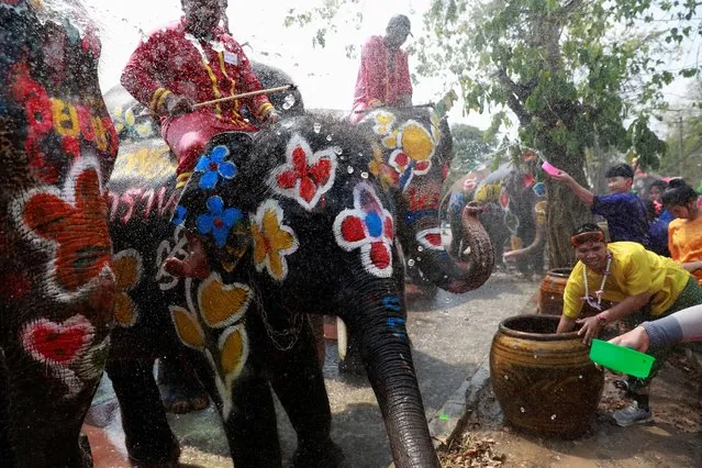 Elephants and people play with water as part of celebrations for the water festival of Songkran in Ayutthaya, Thailand on April 11, 2019. (Photo by Soe Zeya Tun/Reuters)