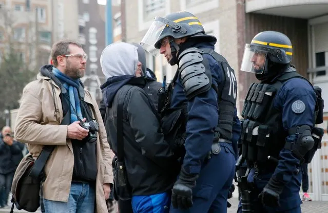 A police officer confronts a youth during a protest against alleged police abuse, Thursday, February 16, 2017 in Bobigny, north of Paris. French authorities have launched Tuesday a new investigation into alleged police abuse by an officer already accused in a rape case that sparked a week of scattered violence in the troubled suburbs of Paris. (Photo by Francois Mori/AP Photo)