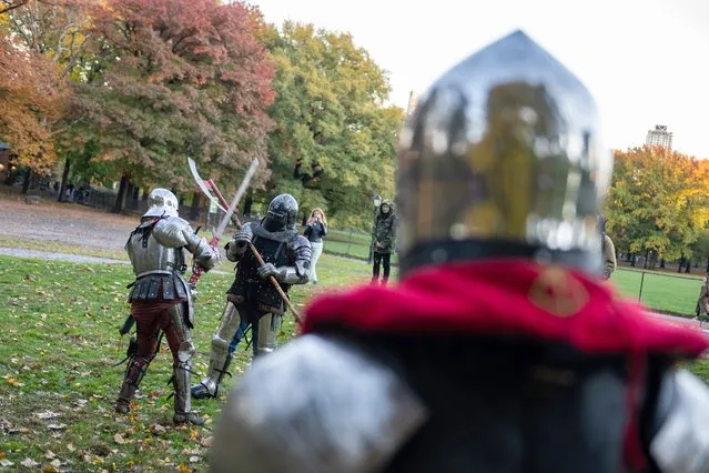Members of Gladiators NYC league dressed in medieval armor fight each other in Central Park with fall colored trees in the background on November 13, 2021 in New York City. Once a month Gladiators NYC meet in Central Park for a full contact combat tournament. People are welcome to watch and interact with the gladiators before and after fighting. It is the oldest armored combat league in New York. (Photo by Alexi Rosenfeld/Getty Images)