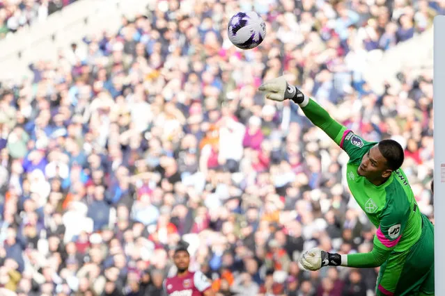 West Ham's goalkeeper Alphonse Areola makes a save during the English Premier League soccer match between West Ham and Aston Villa, at the London stadium in London, Sunday, March 17, 2024. (Photo by Kirsty Wigglesworth/AP Photo)