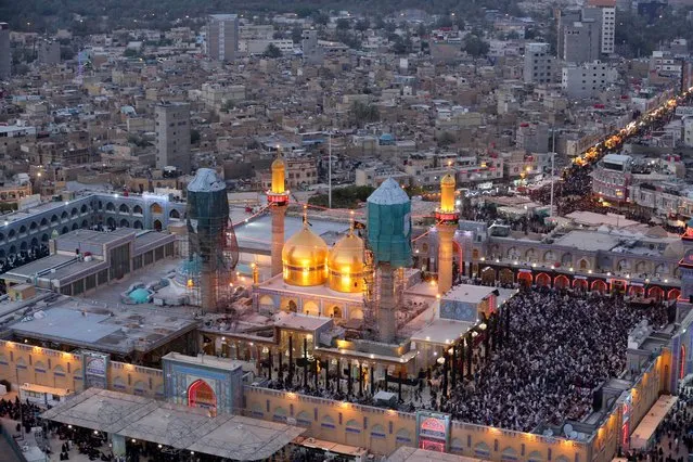 An aerial view of the holy Muslim Shiite shrine of Imam Moussa al-Kazim as pilgrims gather to commemorate his death, in the Shiite district of Kazimiyah, Baghdad, Iraq, Wednesday, May 13, 2015. (Photo by Hadi Mizban/AP Photo)