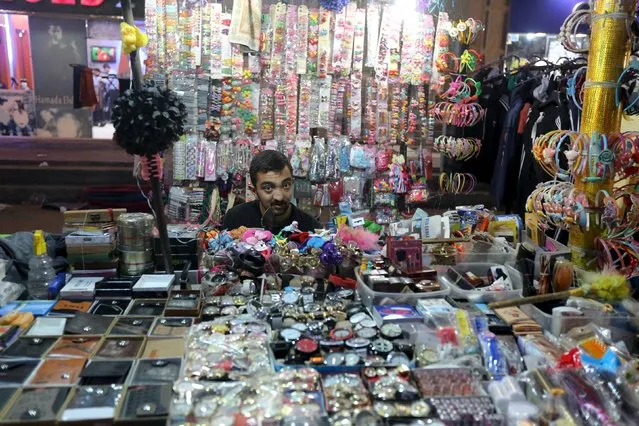 A Syrian street vendor looks from his shop in an area called 6 October City in Giza, Egypt, March 19, 2016. (Photo by Mohamed Abd El Ghany/Reuters)