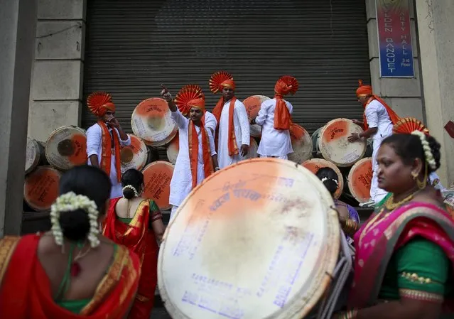 Maharashtrians dressed in traditional costumes collect drums as they attend celebrations to mark the Gudi Padwa festival in Mumbai, India, April 8, 2016. (Photo by Danish Siddiqui/Reuters)