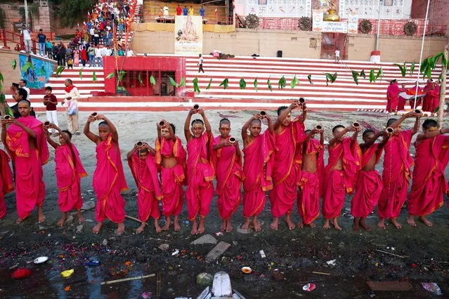 Students from a Hindu religious school pray to the sun god on the occasion of the Hindu new year on the banks of the Ganges River at Kedar Ghat in Varanasi on April 9, 2024. (Photo by Niharika Kulkarni/AFP Photo)