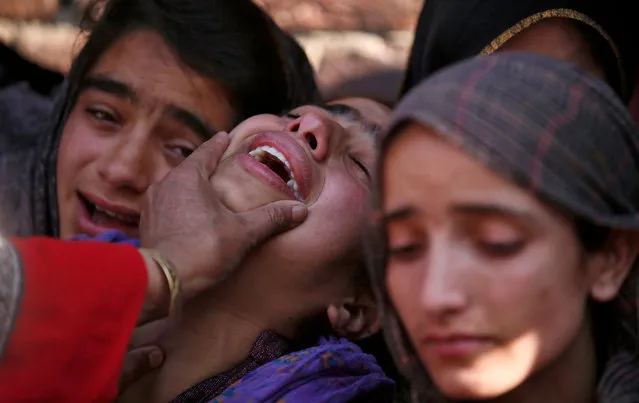 Unidentified relatives of Raja Begum, a civilian, mourn during her funeral in Langate, north of Srinagar, April 13, 2016. Hundreds of Kashmiris on Wednesday participated in the funeral prayers of Begum who was wounded after Indian security forces fired on protesters on Tuesday in north Kashmir's Handwara town, local media reported. Begum passed away in a hospital on Wednesday. (Photo by Danish Ismail/Reuters)