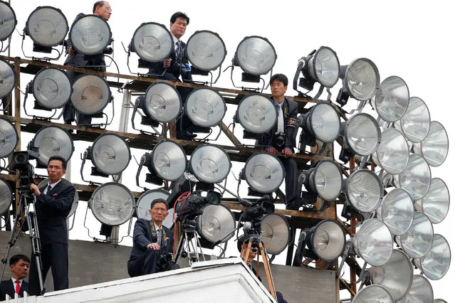 Cameramen take position atop one of buildings in the capital's main ceremonial square during a mass rally and parade, a day after the ruling party wrapped up its first congress in 36 years by elevating him to party chairman, in Pyongyang, North Korea, May 10, 2016. (Photo by Damir Sagolj/Reuters)