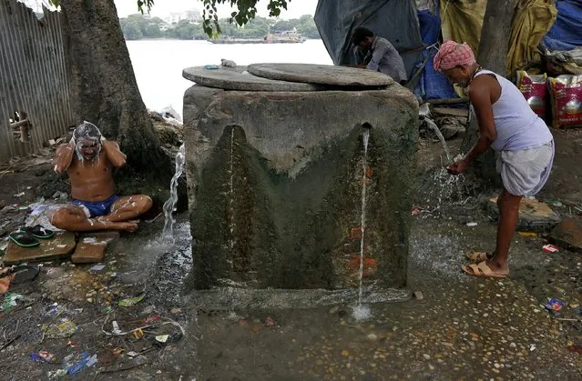 A man bathes at a concrete water pen in Kolkata, India, July 8, 2019. (Photo by Rupak De Chowdhuri/Reuters)