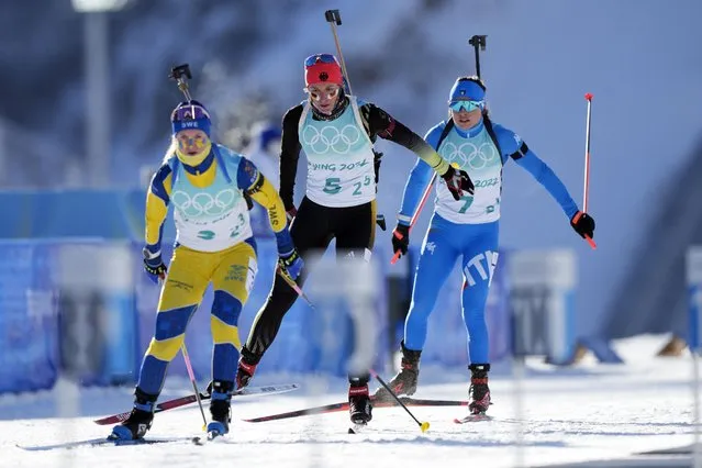 Mona Brorsson of Sweden, left, Vanessa Hinz of Germany and Dorothea Wierer of Italy ski onto the shooting range during the women's 4x6-kilometer relay at the 2022 Winter Olympics, Wednesday, February 16, 2022, in Zhangjiakou, China. (Photo by Frank Augstein/AP Photo)