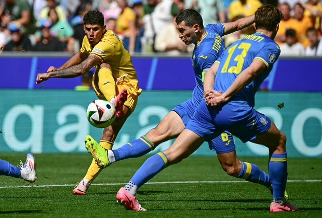 Romania's forward #17 Florinel Coman shoots on target during the UEFA Euro 2024 Group E football match between Romania and Ukraine at the Munich Football Arena in Munich on June 17, 2024. (Photo by Tobias Schwarz/AFP Photo)