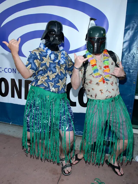 Fans wearing “Star Wars” character masks Darth Vader, left, and Boba Fett attend day 1 of Comic-Con International on Thursday, July 9, 2015, in San Diego, Calif. (Photo by Tonya Wise/Invision/AP Photo)