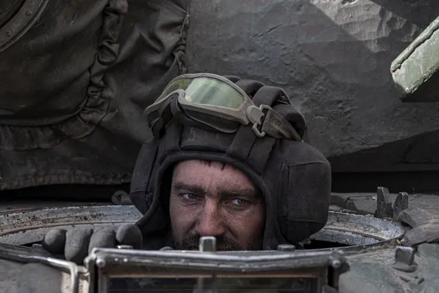 A Ukranian serviceman sits inside a Russian tank captured after fighting with Russian troops in the village of Lukyanivka outside Kyiv, as Russia's invasion of Ukraine continues, Ukraine, March 27, 2022. (Photo by Marko Djurica/Reuters)