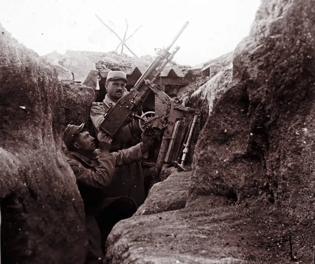 An undated archive picture shows a French soldier aiming an anti-aircraft machine gun from a trench at Perthes les Hurlus, eastern France. (Photo by Collection Odette Carrez/Reuters)