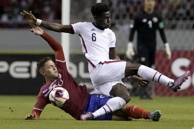 Costa Rica's Brandon Aguilera, below, and United States' Yunus Musah battle for the ball during a qualifying soccer match for the FIFA World Cup Qatar 2022 in San Jose, Costa Rica, Wednesday, March 30, 2022. (Photo by Moises Castillo/AP Photo)