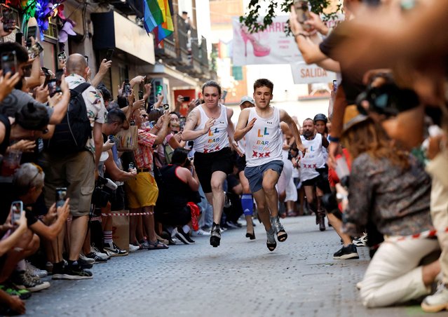 Contestants take part in the annual race on high heels during Pride celebrations in the quarter of Chueca in Madrid, Spain on July 4, 2024. (Photo by Juan Medina/Reuters)