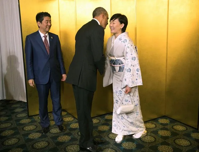 Japanese Premier Shinzo Abe and his wife, Akie Abe, the First Lady, greet U.S. President Barack Obama before the start of a cocktail reception at the G7 Summit in Ise-Shima, Japan, Thursday, May, 26, 2016. (Photo by Doug Mills/Reuters)
