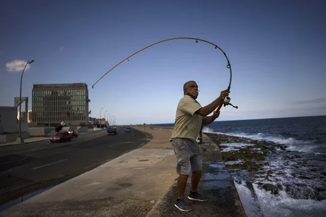 A fisherman casts his lure into coastal waters near the United States Embassy, in Havana, Cuba, Thursday, March 3, 2022. (Photo by Ramon Espinosa/AP Photo)