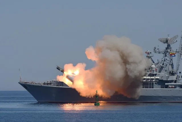 Missiles are fired by a Russian navy battleship during a rehearsal of the Russian Navy Day parade in Sevastopol, Crimea, Friday, July 24, 2015. (Photo by Alexander Polegenko/AP Photo)