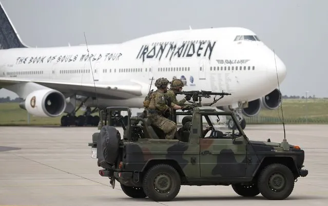 German armed forces Bundeswehr soldiers on their vehicle perform a rescue and evacuation operation in front of the Ed Force One, the aeroplane of British heavy metal band Iron Maiden at the ILA Berlin Air Show in Schoenefeld, south of Berlin, Germany, May 31, 2016. (Photo by Fabrizio Bensch/Reuters)