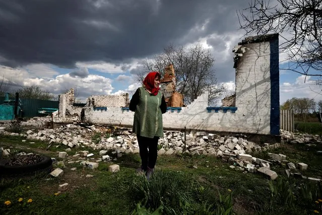 Lyubov Lenko, 61, reacts as she shows her house that according to her was destroyed by shelling, amid the Russian invasion of Ukraine in Budy, Chernihiv region, Ukraine on May 3, 2022. (Photo by Zohra Bensemra/Reuters)