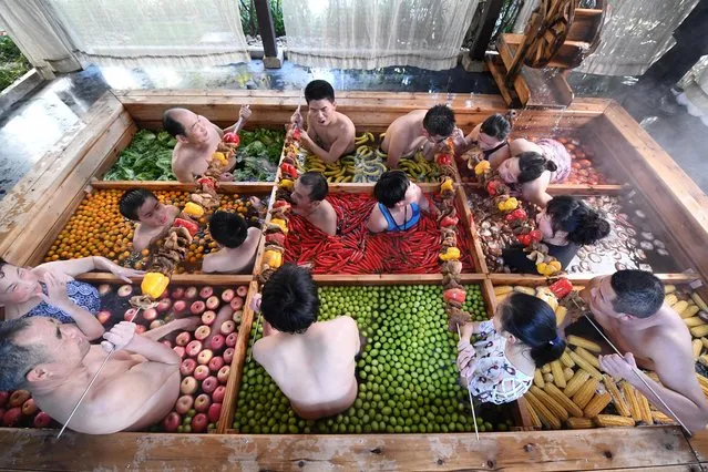 People enjoy a barbecue as they bath in a hotpot-shaped hot spring filled with fruits and vegetables, at hotel in Hangzhou, Zhejiang province, China, January 27, 2019. (Photo by Reuters/China Stringer Network)