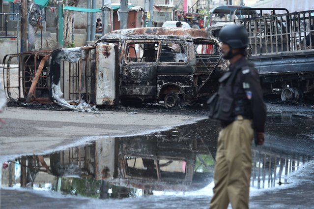 Pakistani security officials patrol the scene of clashes between two armed groups in Karachi, Pakistan, 25 August 2024. Clashes in Karachi's Golimar left two dead, with nine others injured, Police confirmed. City police chief Javed Odho stated that the situation is under control, with a large police and rangers deployed. (Photo by Shahzaib Akber/EPA/EFE)