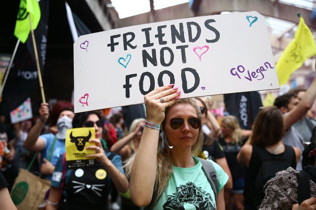 An animal rights protestor hold a placard saying “Friends Not Food” during a march through central London on August 28, 2021 in London, England. The demonstration is part of the “August Rebellion”. (Photo by Hollie Adams/Getty Images)