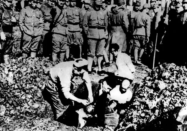 Five Chinese prisoners of war are buried alive by their Japanese captors just outside Nanking after the fall of the Chinese capital, on December 1937.  (Photo by Keystone/Getty Images)