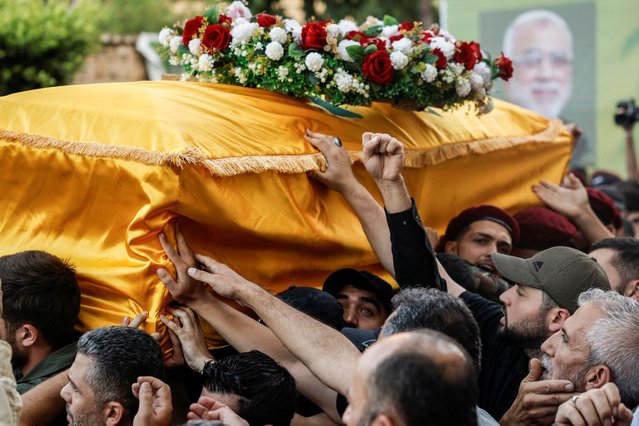 Mourners carry Hezbollah senior commander Ibrahim Qubaisi's coffin during a funeral for him and Hezbollah commander Hussein Ezzedine, who were killed in Tuesday's Israeli strike on Beirut's southern suburbs, Lebanon on September 25, 2024. (Photo by Louisa Gouliamaki/Reuters)