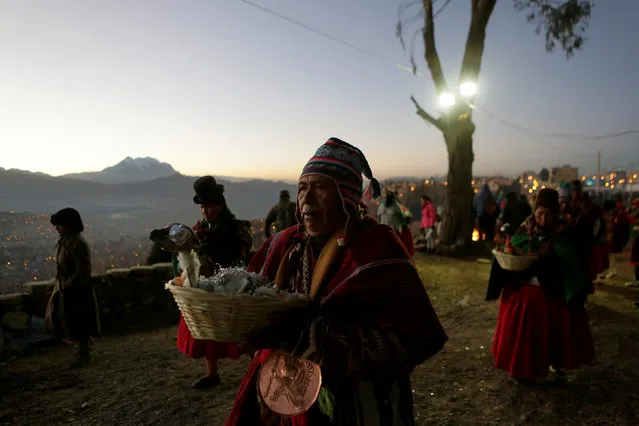 Aymara witch doctors hold offerings before a ceremony in El Alto near La Paz, Bolivia, June 21, 2016. (Photo by David Mercado/Reuters)
