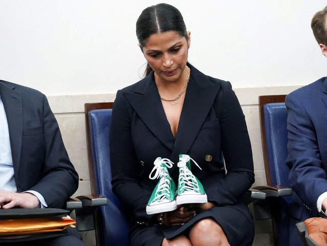 Camila Alves McConaughey, a model, designer and the wife of actor Matthew McConaughey, holds a pair of sneakers used to identify one of the student victims as her husband speaks to reporters about the recent mass shooting at an elementary school in his hometown of Uvalde, Texas during a press briefing at the White House in Washington, U.S., June 7, 2022. (Photo by Kevin Lamarque/Reuters)